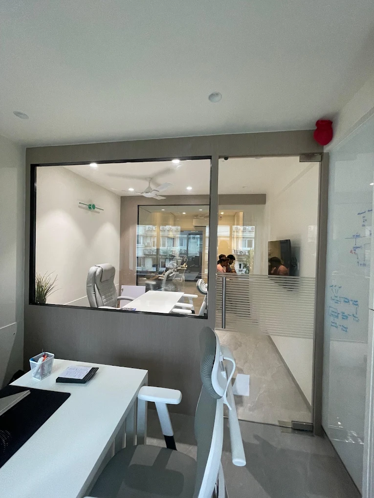 Meeting area and glass partitions inside the Beacon Minds Mumbai office