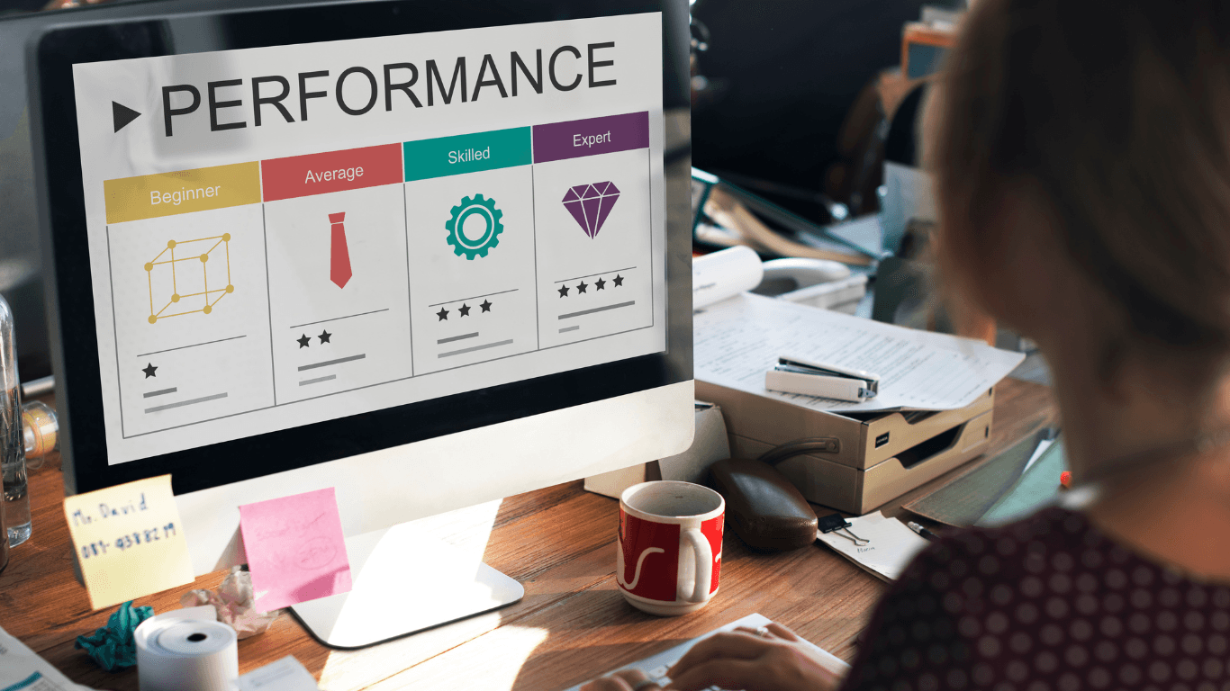 Person using a computer with a performance evaluation chart on the screen.